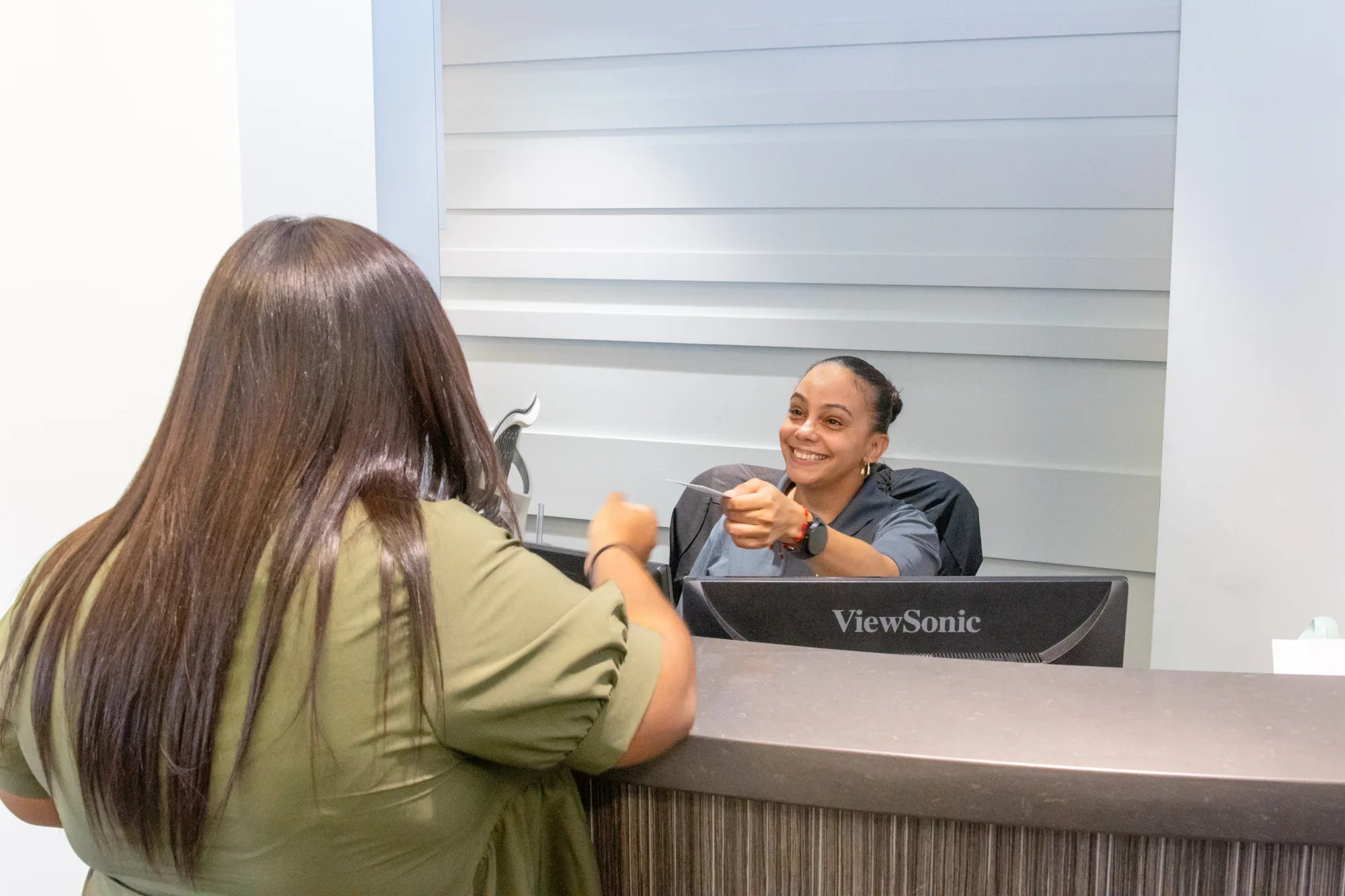 A patient checking in at the OIC Inspired front desk