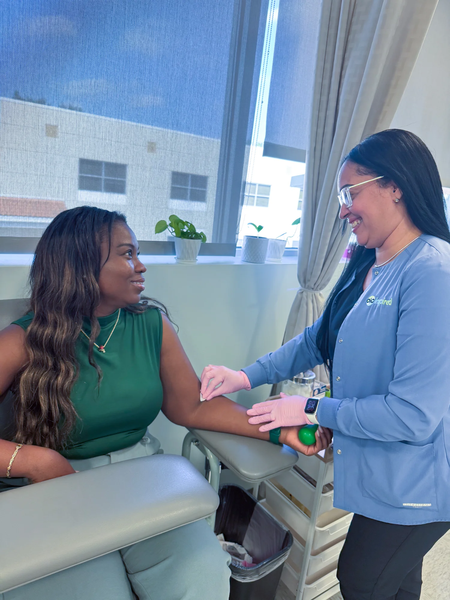 OIC Inspired lab staff drawing blood from a patient