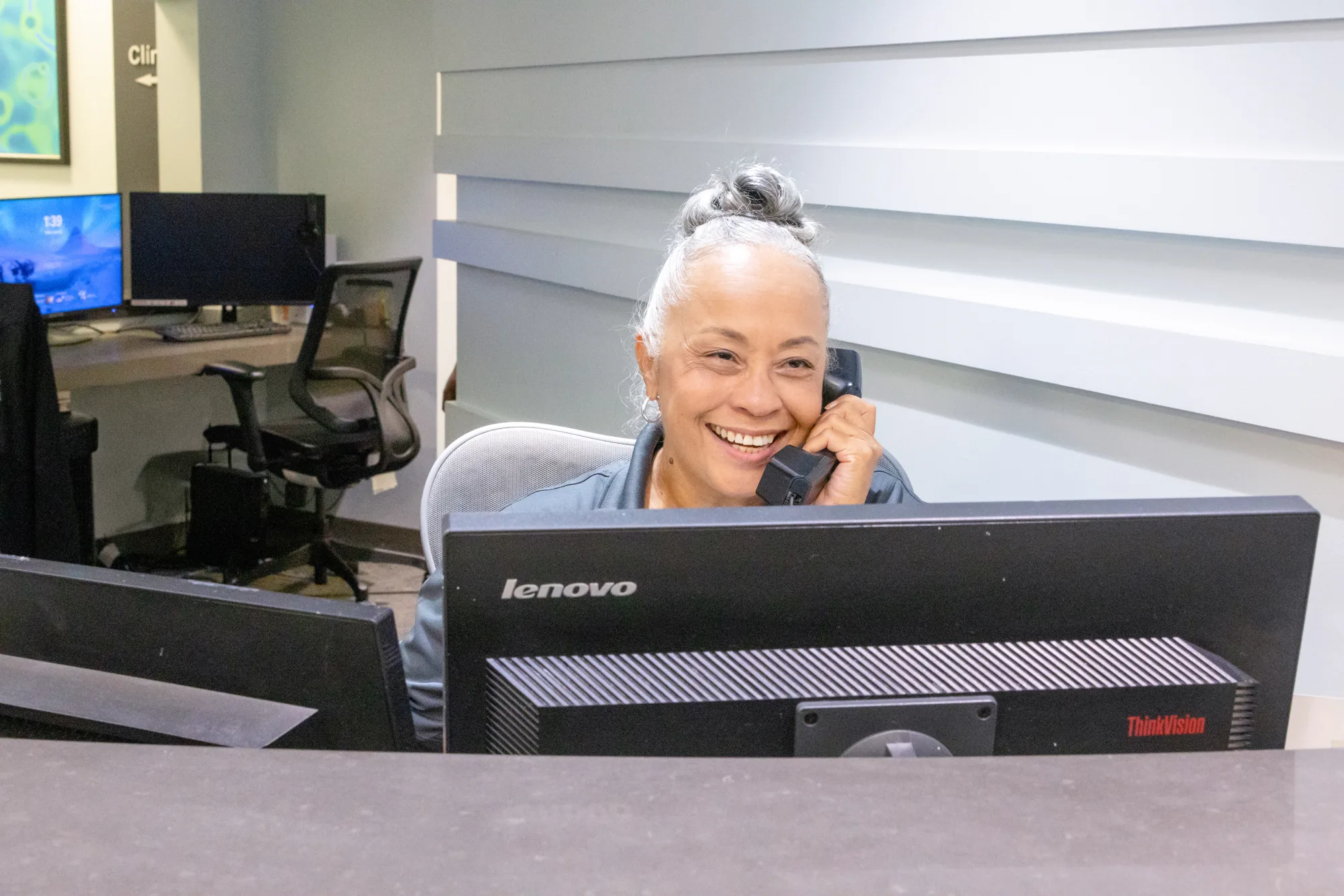 OIC Inspired staff member answering a call at the front desk