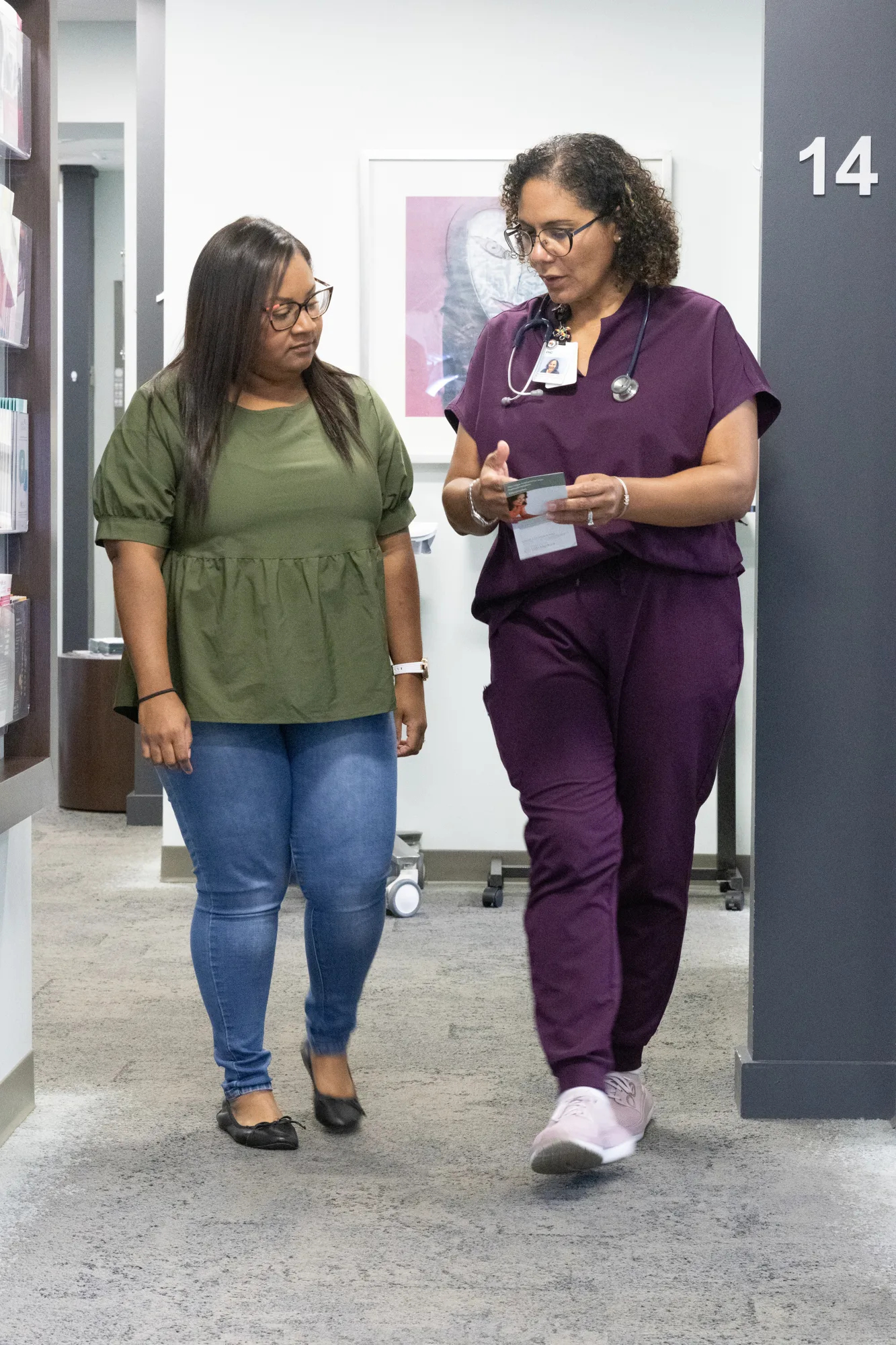 An OIC Inspired nurse practitioner walking with a patient