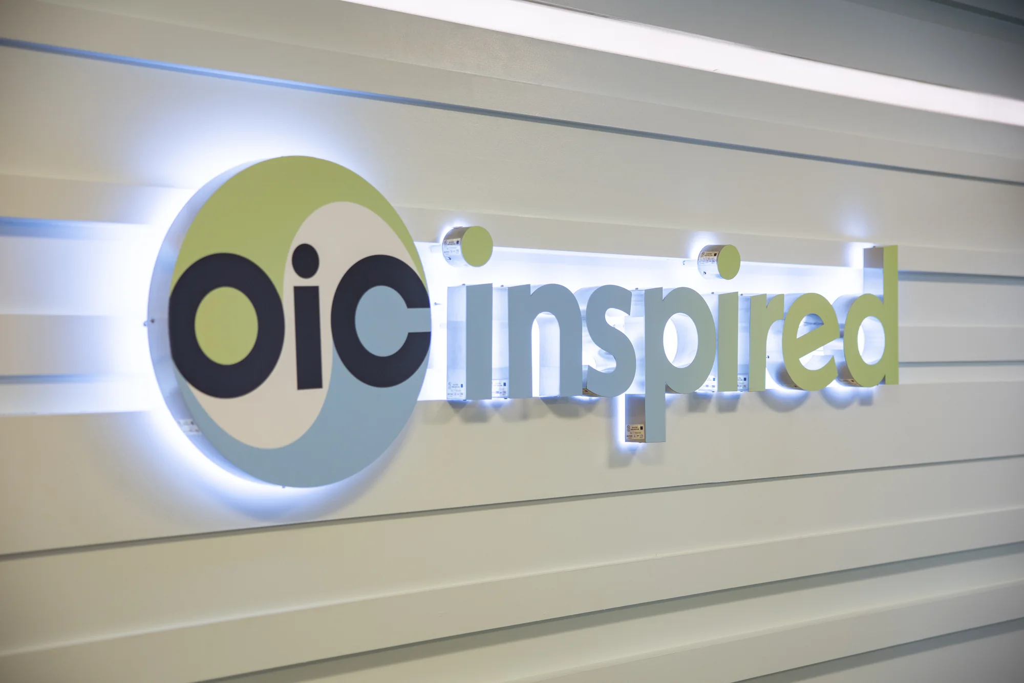 The illuminated OIC Inspired sign in the clinic lobby